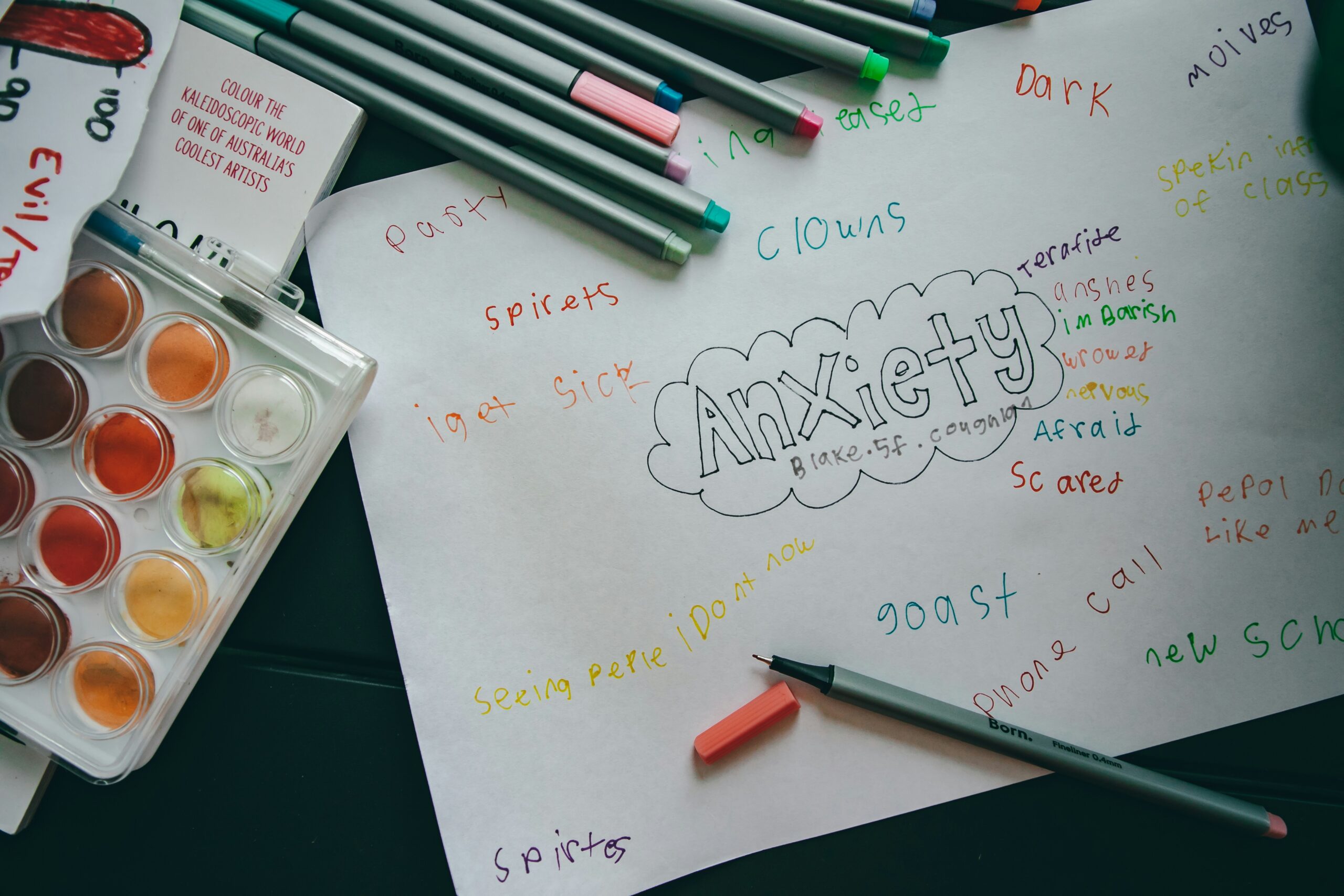 Person writing in a journal to manage anxiety, organise thoughts, and support emotional wellbeing.